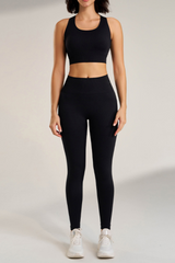 Person wearing a black athletic ribbed outfit sosala set of bralet and leggings on a plain background
